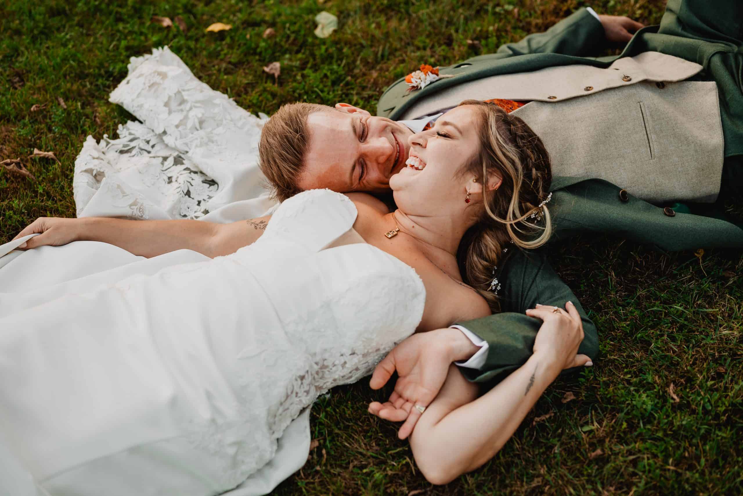 A bride laughs as her father dances behind her.